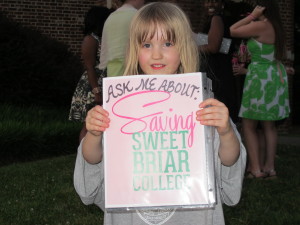 A young girl (future student?) holds up the notebook I carried throughout Reunion weekend, 2015.