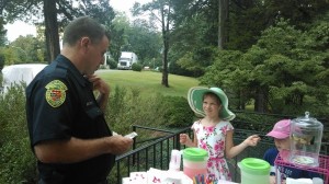 Children of alumnae sold lemonade, donuts, cookies and art to benefit their Mom's College. In this photo, Joan Dabney Clinker's daughter sells a donut to campus security.