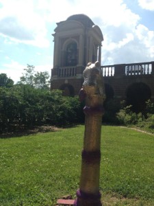 The hitching post painted the colors of 1988, gold and purple, with the bell tower in the background.